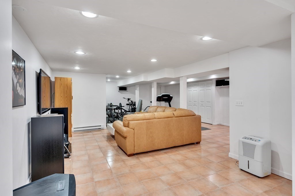 1031 Boston Post Road Sudbury, MA 01776 - Photo 32 of 36 a living room with furniture and a flat screen tv