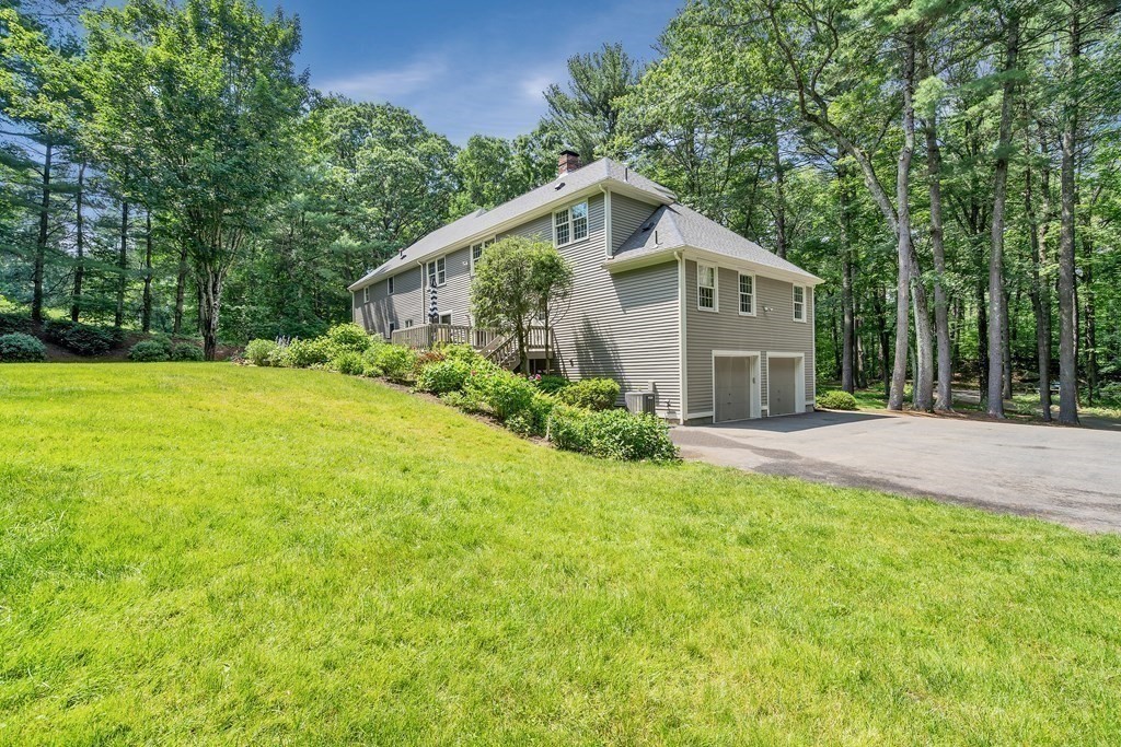 1031 Boston Post Road Sudbury, MA 01776 - Photo 34 of 36 a house with trees in the background