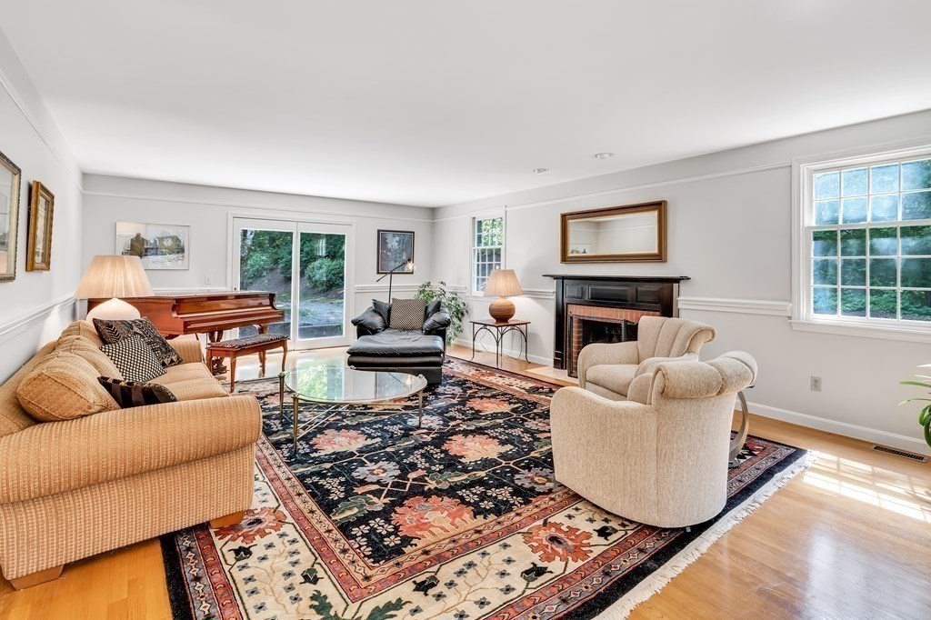 1031 Boston Post Road Sudbury, MA 01776 - Photo 8 of 36 a living room with furniture a rug a window and a fireplace