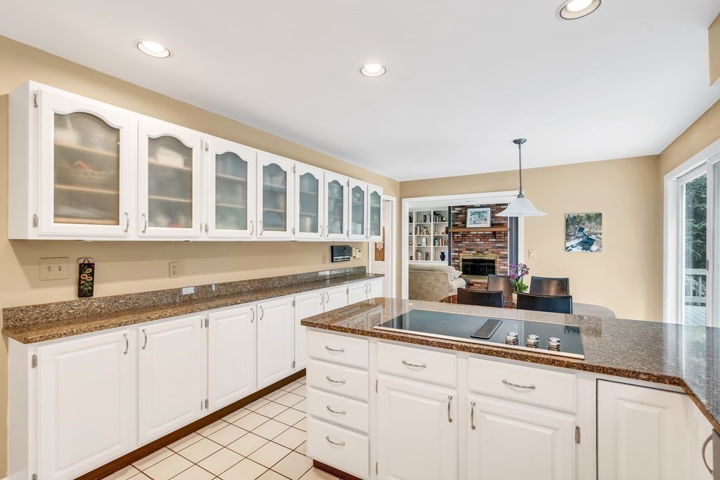 1031 Boston Post Road Sudbury, MA 01776 - Photo 10 of 36 a kitchen with granite countertop white cabinets and white appliances