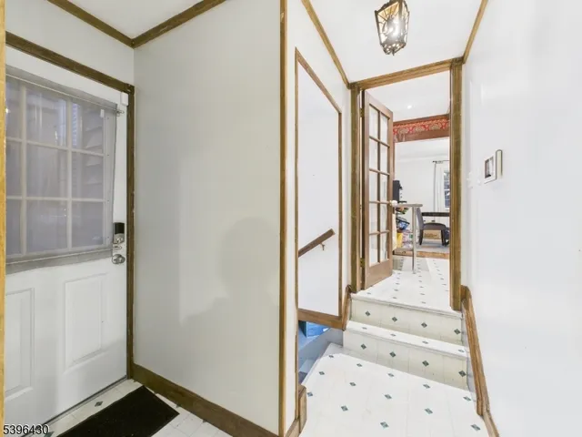 a view of a hallway view with wooden floor and windows