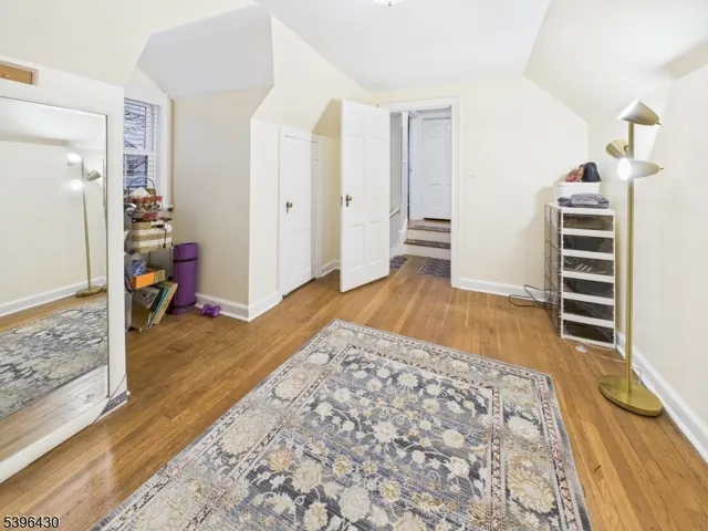 a view of room with furniture and wooden floor