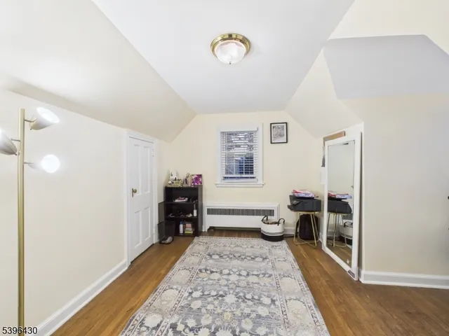 a view of a bedroom with furniture and window