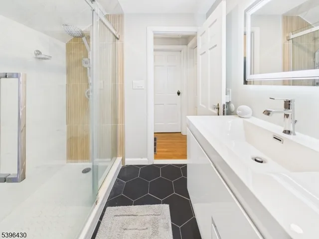 a bathroom with a tub sink and shower