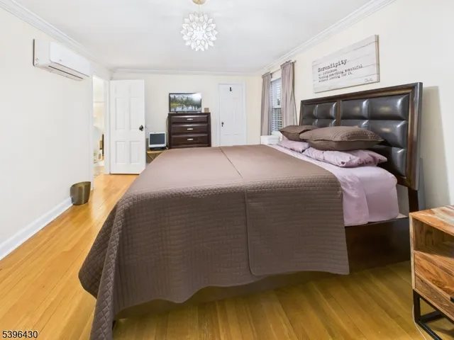 a bedroom with a bed and a chandelier