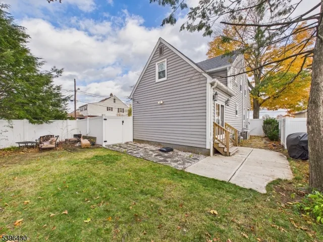 a backyard of a house with plants and trees