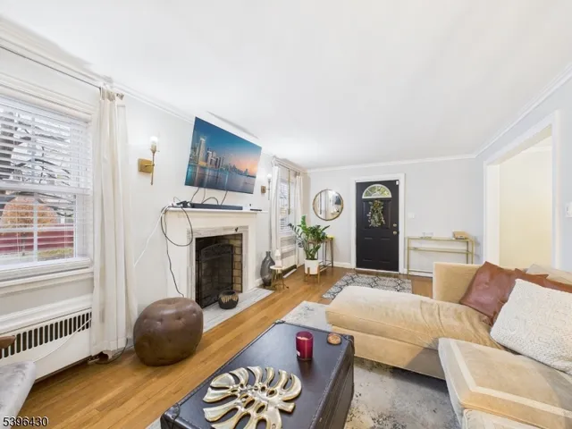 a living room with furniture a fireplace and windows