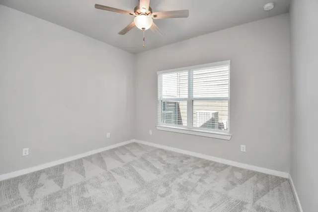 a view of house with a big yard and large tree