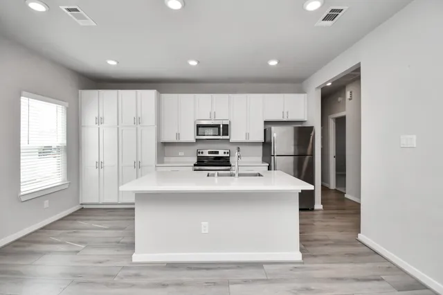 a bathroom with a toilet a sink and shower