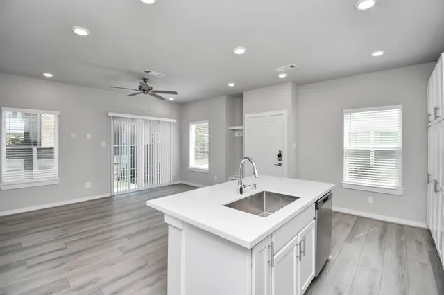 an empty room with closet and a chandelier fan