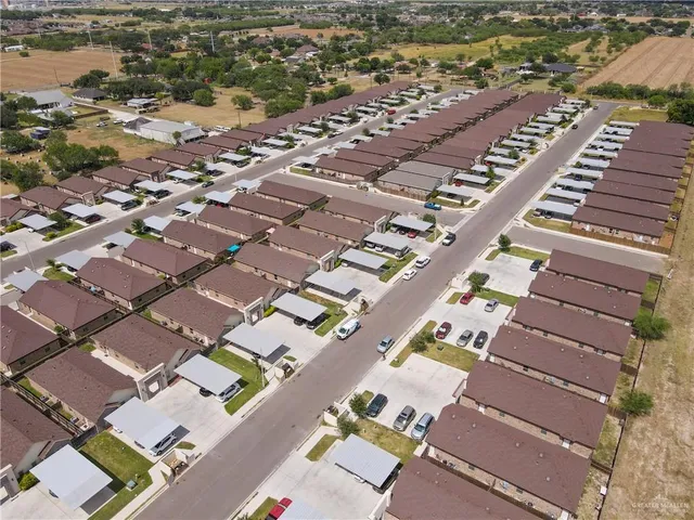 an aerial view of residential houses with outdoor space
