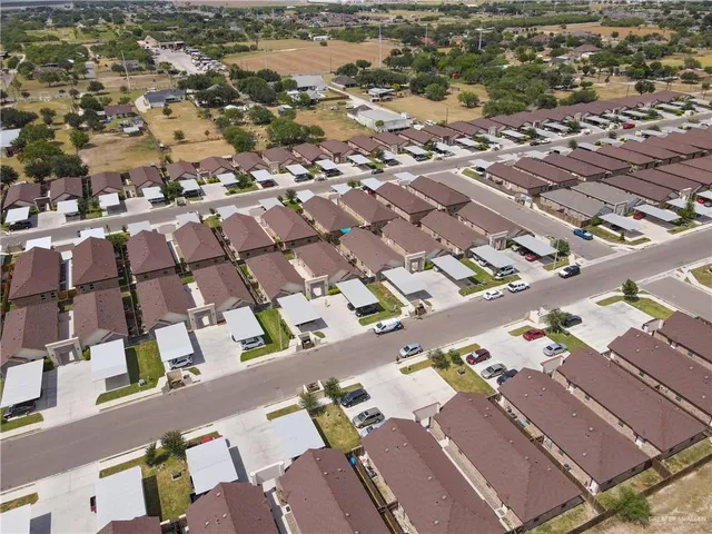 an aerial view of residential building and lake
