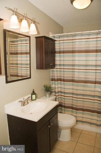 1201 North Point Road Dundalk, MD 21222 - Photo 2 of 17 a bathroom with a sink vanity granite toilet and a mirror