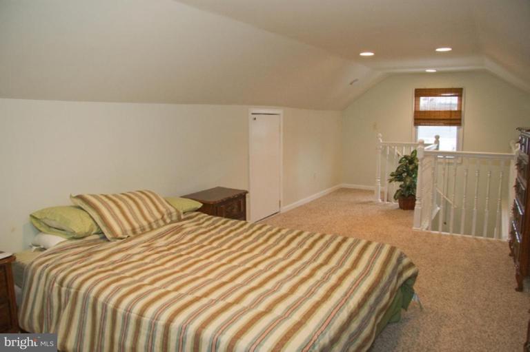 1201 North Point Road Dundalk, MD 21222 - Photo 13 of 17 a bedroom with a bed and a night stand