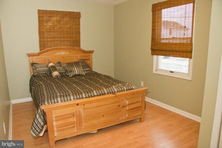 1201 North Point Road Dundalk, MD 21222 - Photo 4 of 17 a bed sitting in a bedroom next to a window