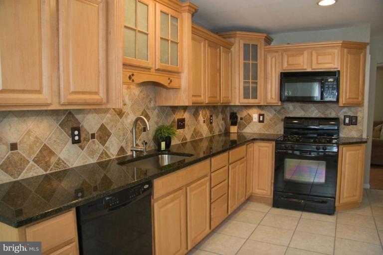 1201 North Point Road Dundalk, MD 21222 - Photo 9 of 17 a kitchen with stainless steel appliances granite countertop a sink stove and microwave