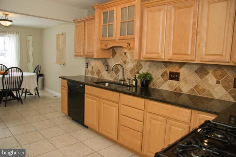 1201 North Point Road Dundalk, MD 21222 - Photo 10 of 17 a kitchen with stainless steel appliances granite countertop a sink and cabinets