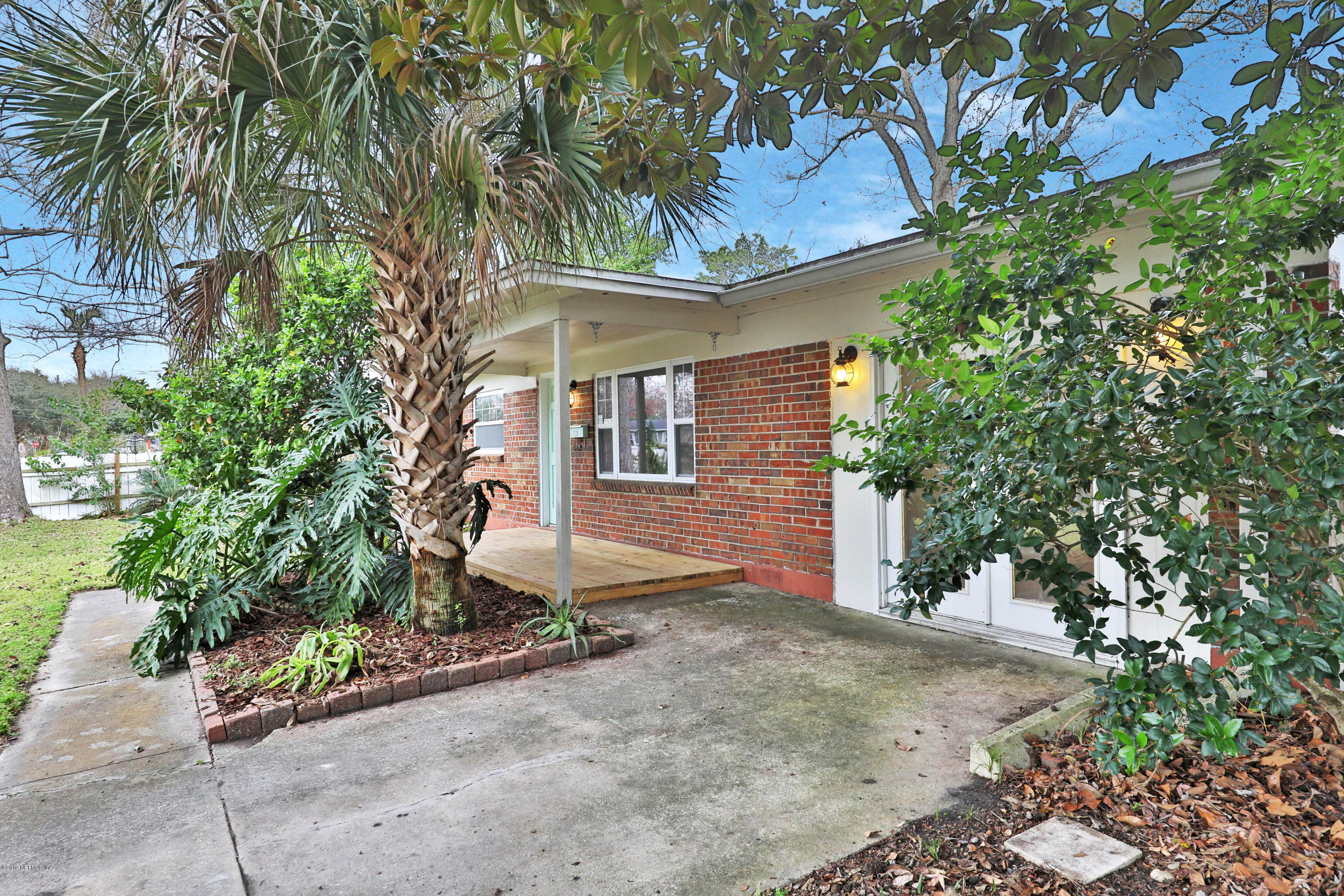 front view of a house with a tree