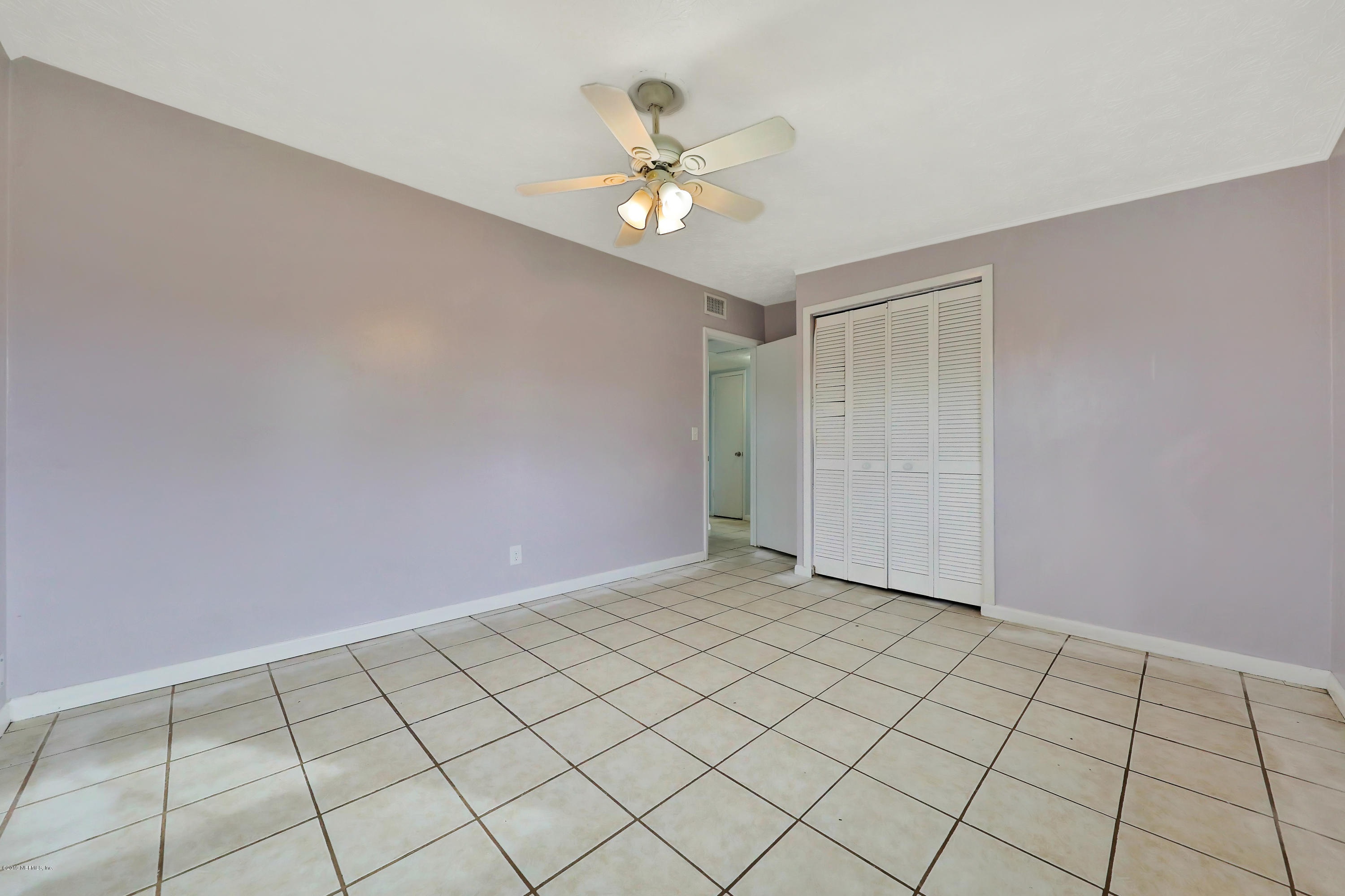 451 Sargo Road Atlantic Beach, FL 32233 - Photo 13 of 18 a view of an empty room and chandelier fan