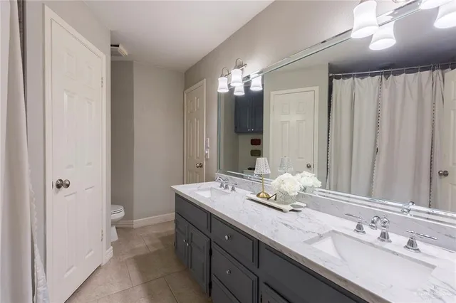 a bathroom with double vanity sinks a vanity and a mirror