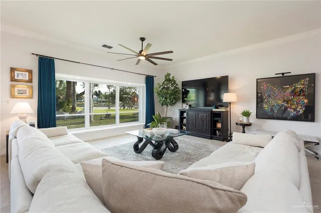 a living room with furniture large window and a flat screen tv