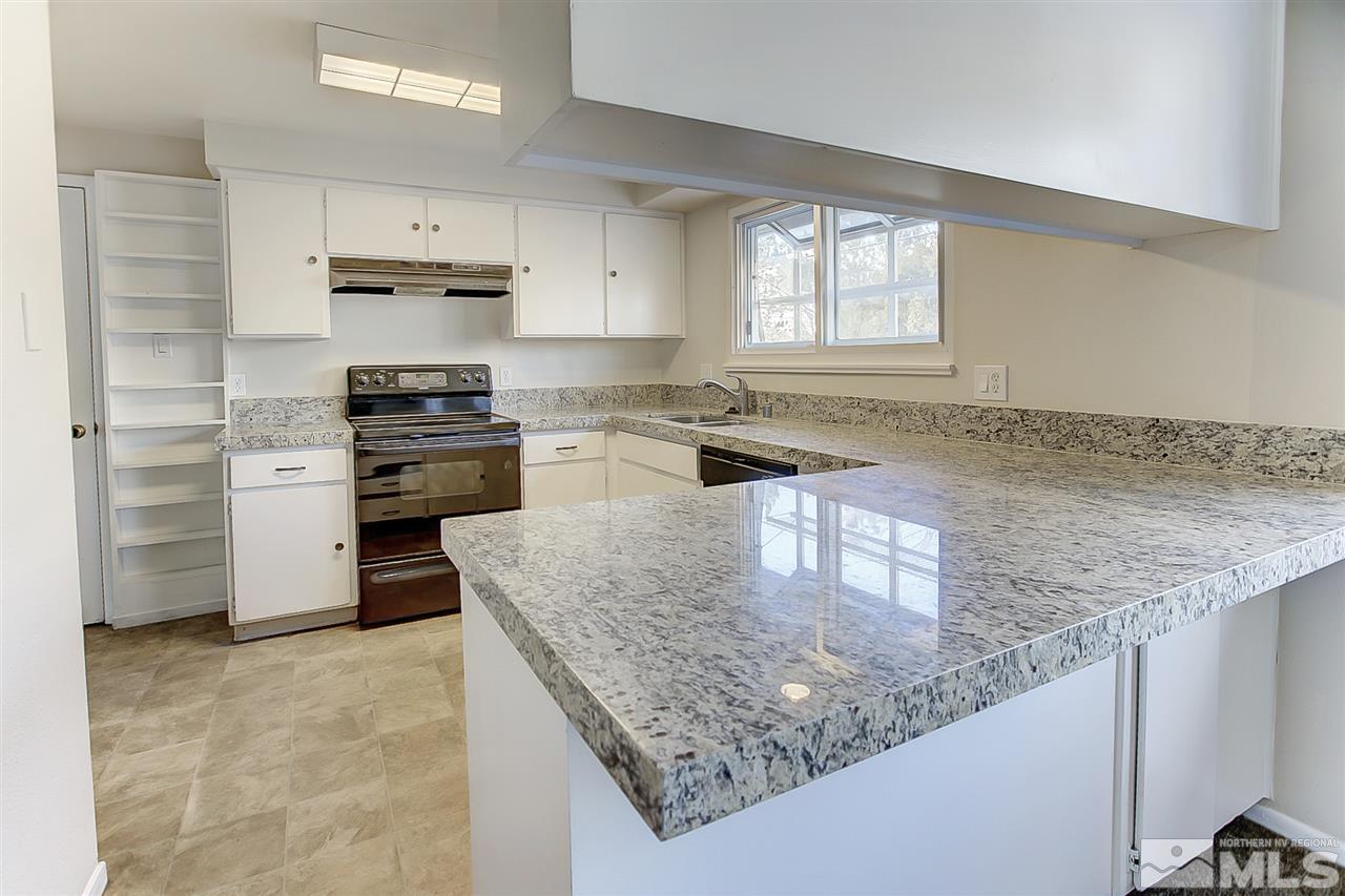 915 Autumn Reno, NV 89511 - Photo 1 of 1 a kitchen with stainless steel appliances granite countertop a sink stove and refrigerator