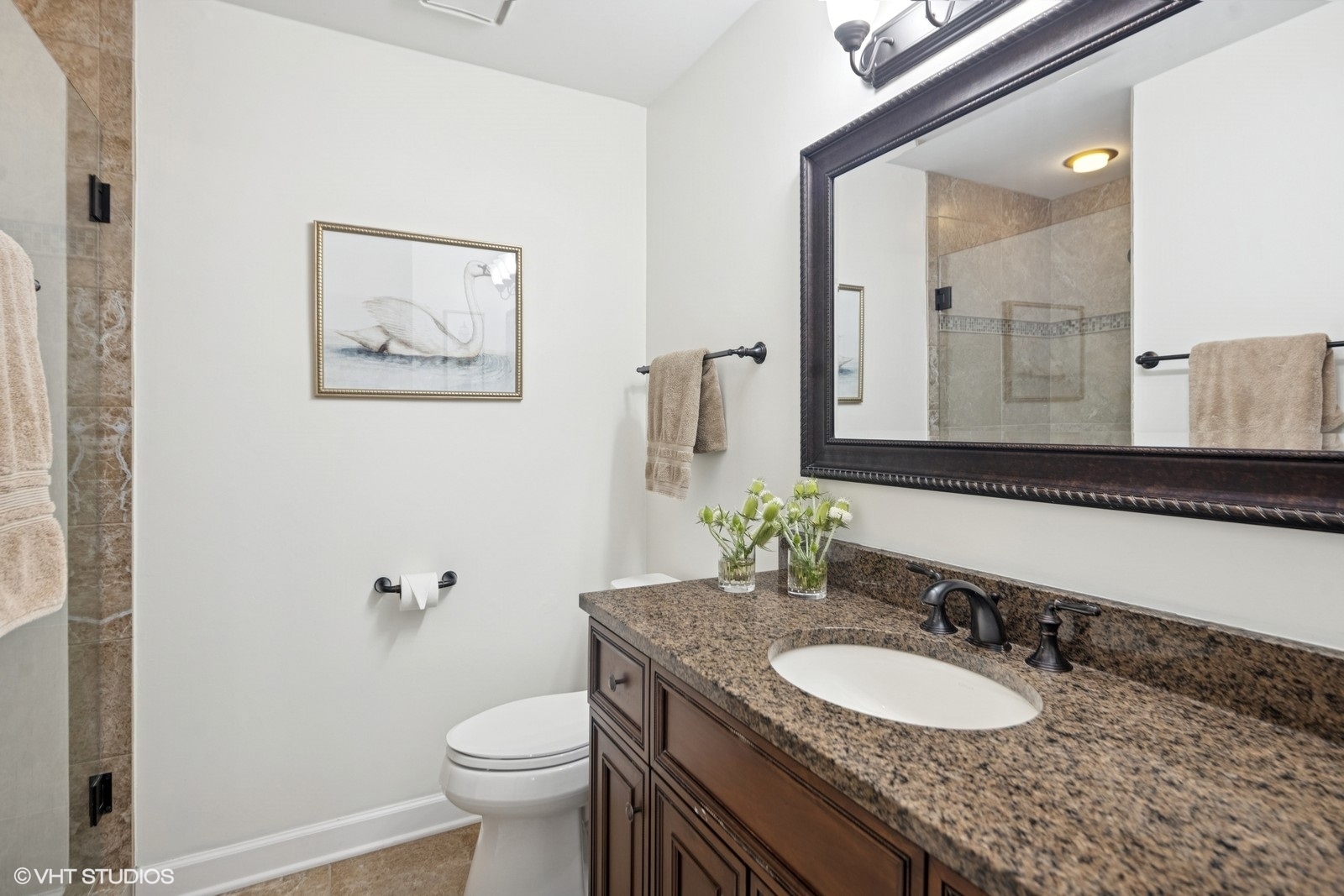 199 Springdale Lane Bloomingdale, IL 60108 - Photo 33 of 70 a bathroom with a granite countertop toilet a sink and a mirror