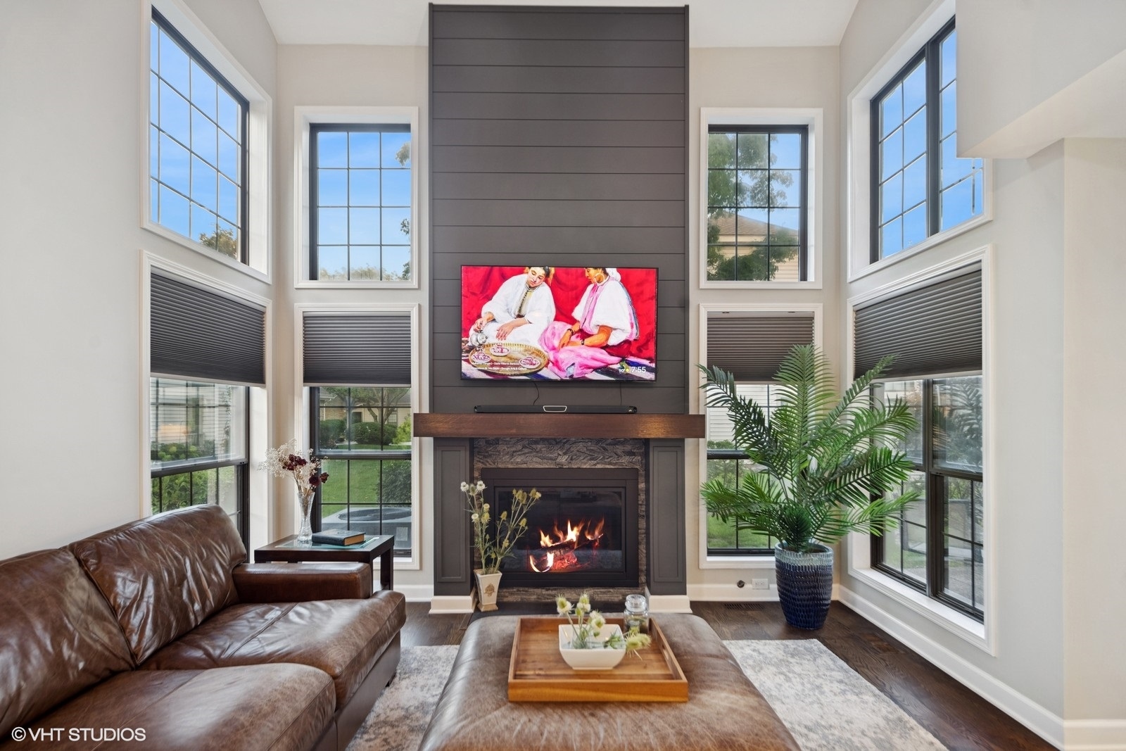 199 Springdale Lane Bloomingdale, IL 60108 - Photo 10 of 70 a living room with furniture a fireplace and a flat screen tv