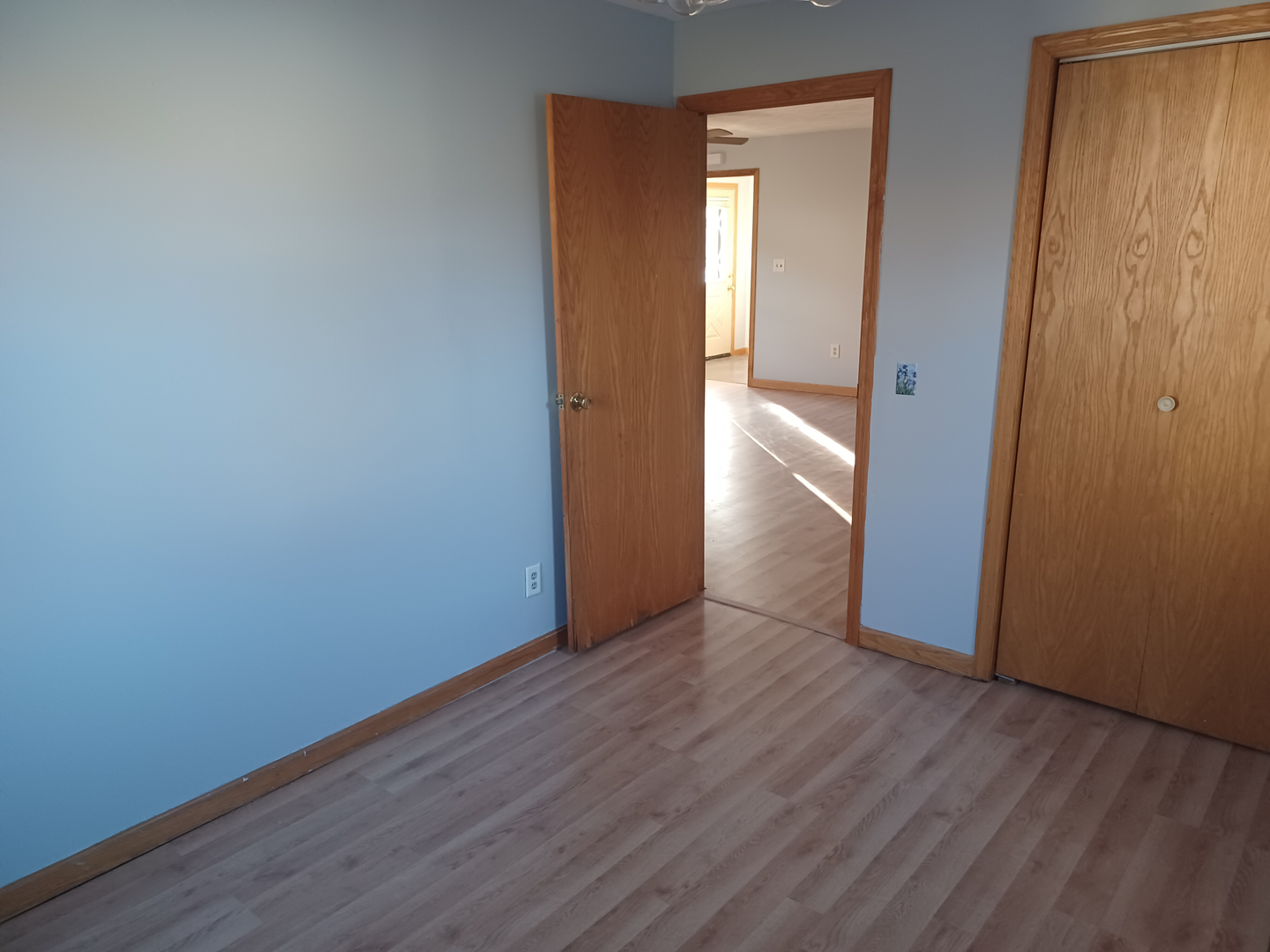206 South Stott Street Genoa, IL 60135 - Photo 11 of 18 a view of an empty room with wooden floor and a window