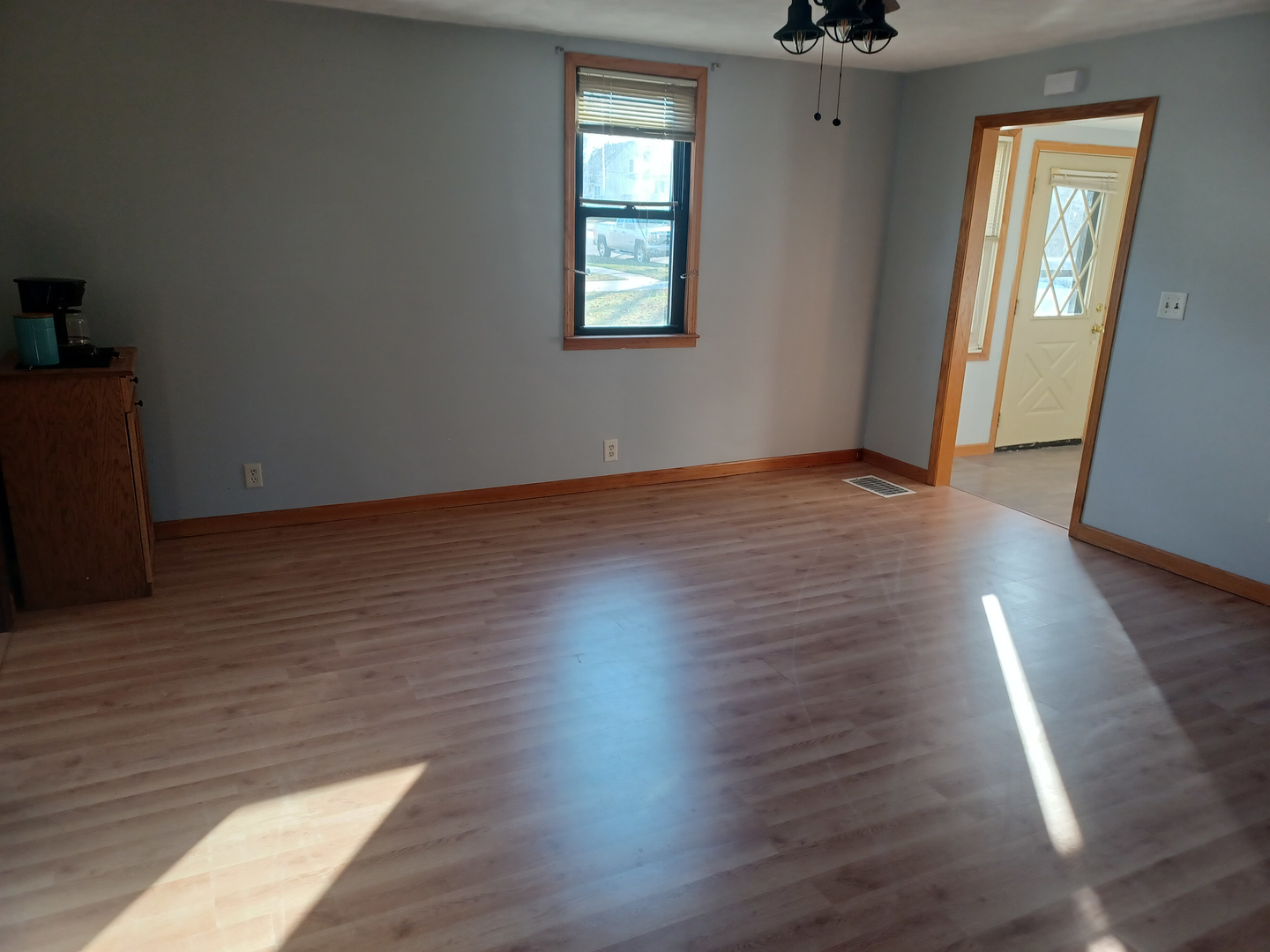206 South Stott Street Genoa, IL 60135 - Photo 5 of 18 an empty room with wooden floor and windows