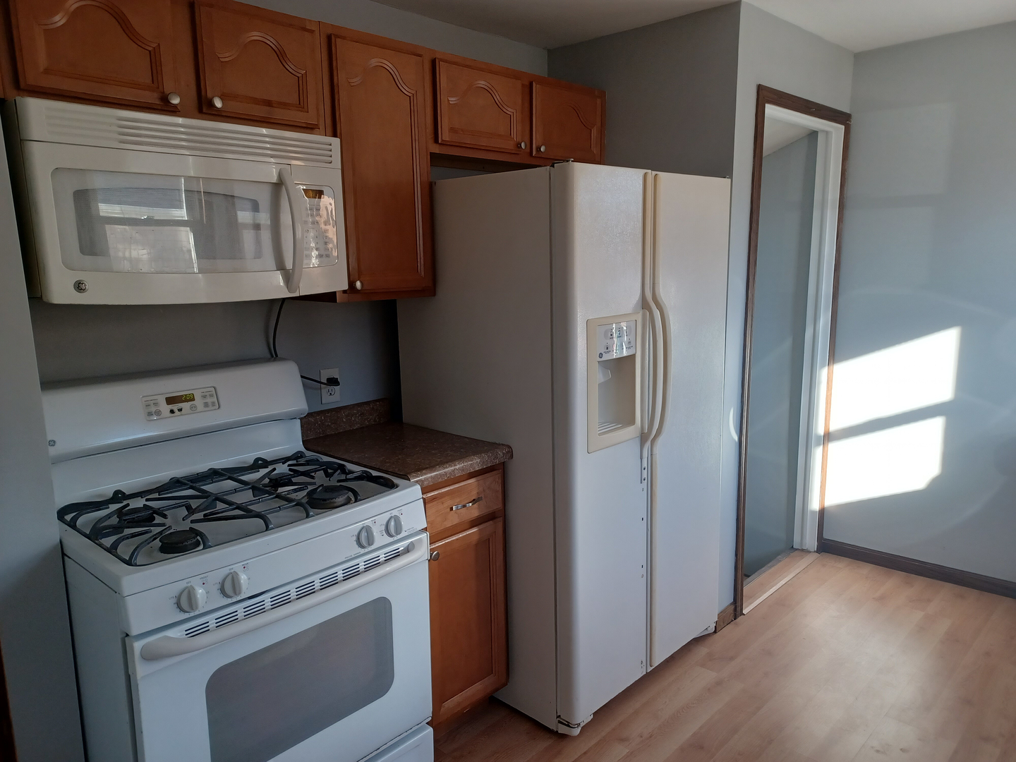 206 South Stott Street Genoa, IL 60135 - Photo 7 of 18 a white refrigerator freezer and a stove sitting inside of a kitchen