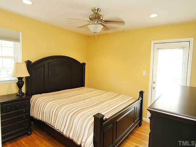 1812 Euclid Road Durham, NC 27713 - Photo 6 of 13 a bedroom with a bed and a chandelier