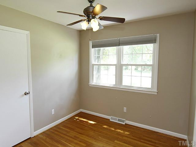 1812 Euclid Road Durham, NC 27713 - Photo 9 of 13 an empty room with a window and a fan