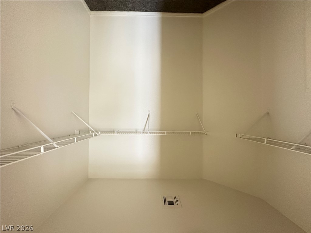 7305 Prussian Green Street Las Vegas, NV 89139 - Photo 9 of 23 Ample shelving in this well-organized walk-in closet offers extensive storage solutions.