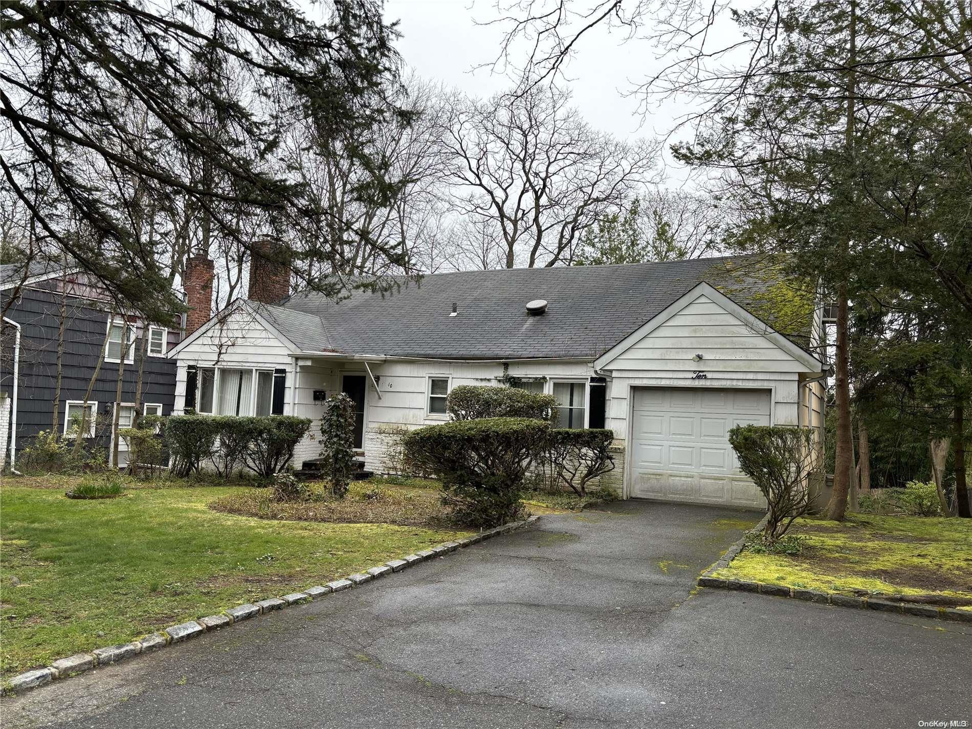 10 West Terrace Road Great Neck, NY 11023 - Photo 1 of 1 a front view of a house with a garden