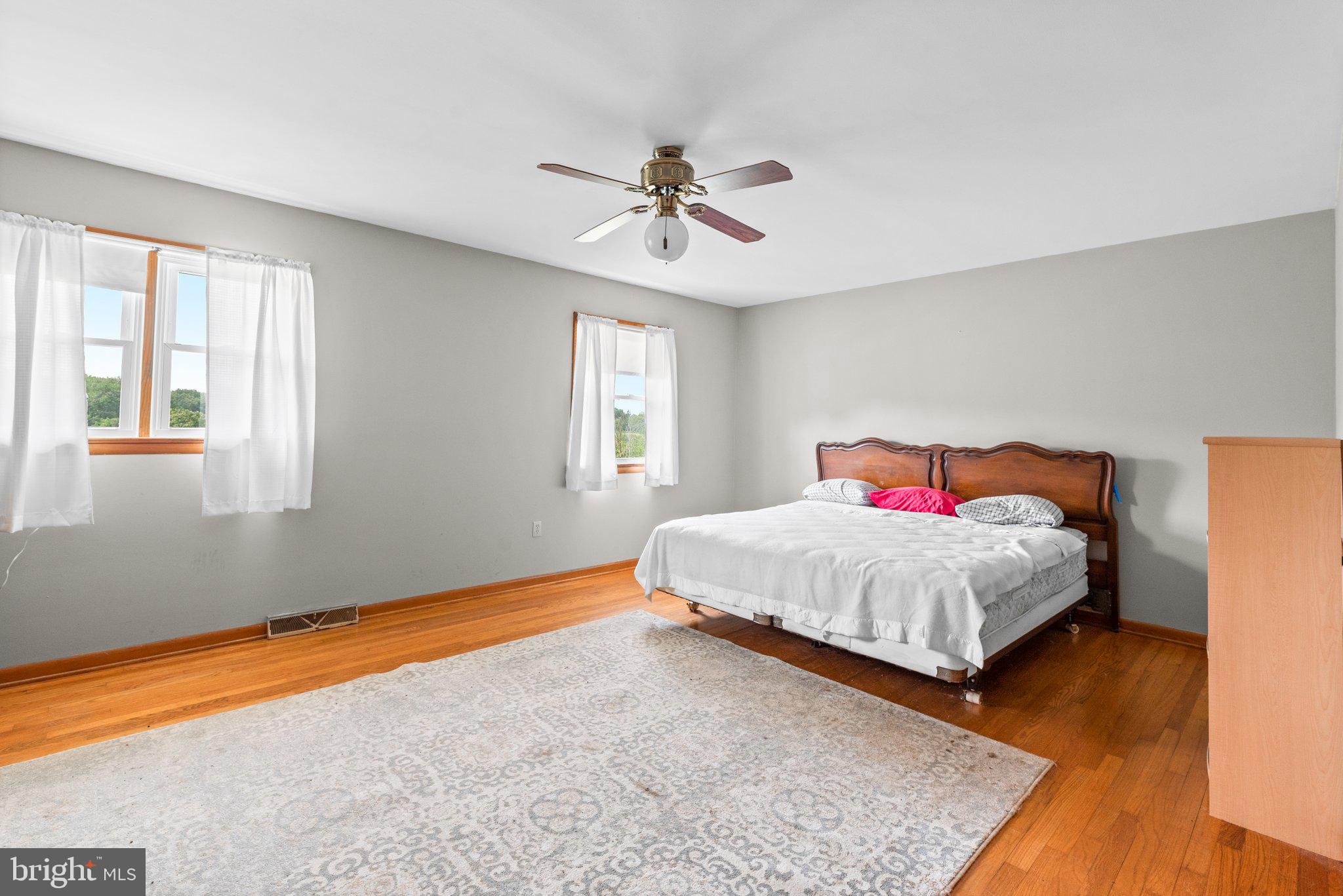 10110 Old Liberty Road Frederick, MD 21701 - Photo 11 of 65 a bedroom with a bed and wooden floor
