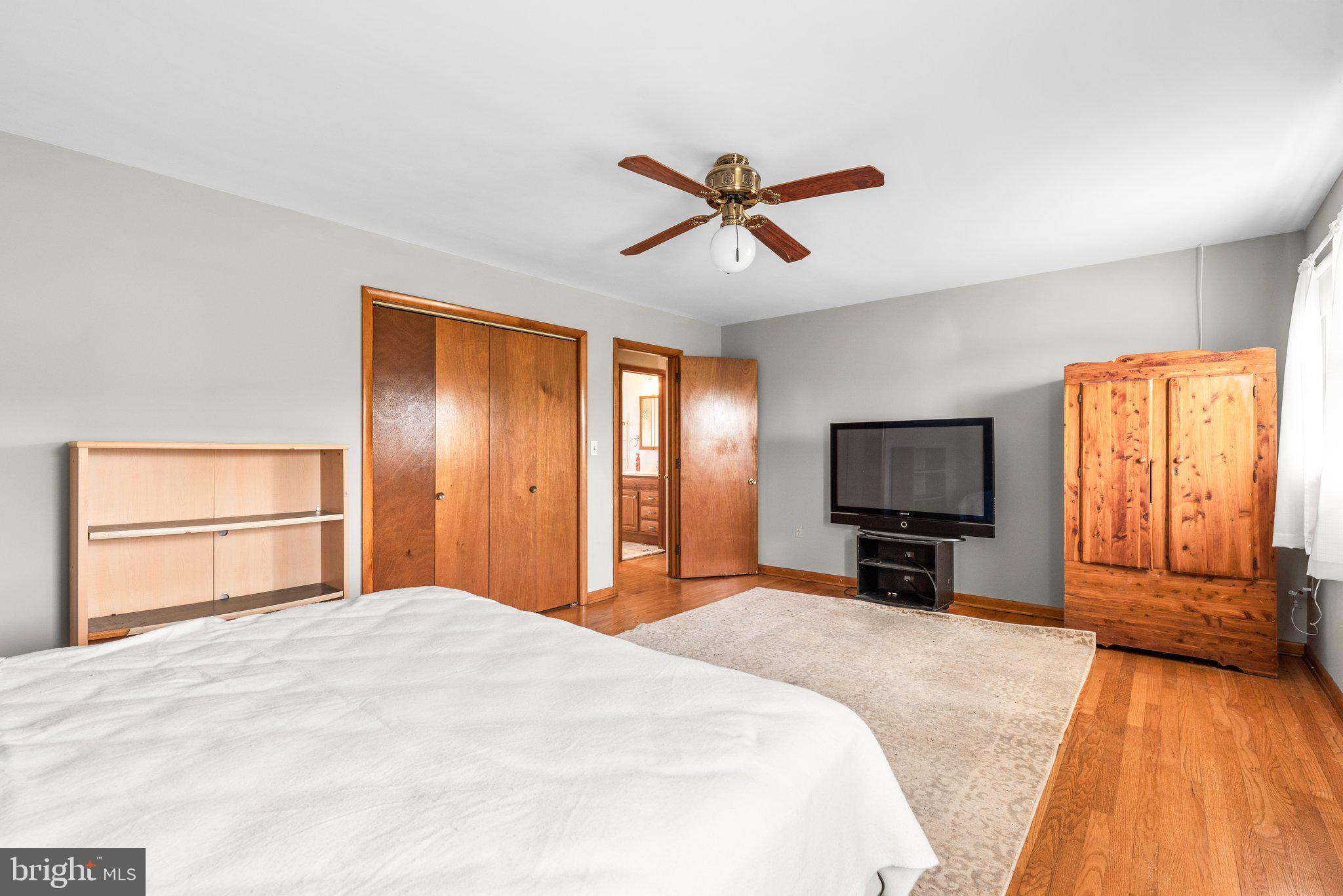 10110 Old Liberty Road Frederick, MD 21701 - Photo 13 of 65 a bedroom with a bed and a flat screen tv