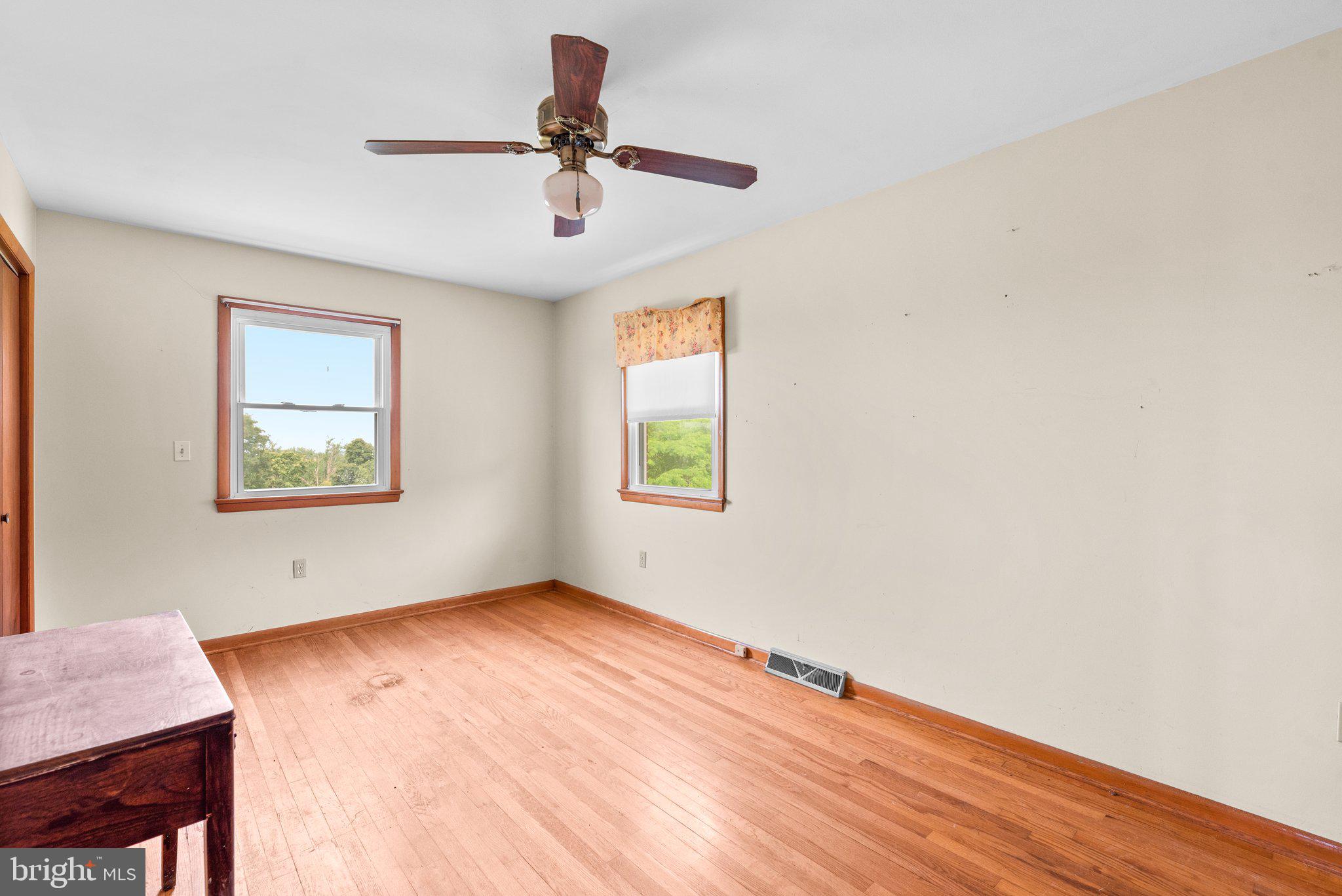 10110 Old Liberty Road Frederick, MD 21701 - Photo 14 of 65 a view of empty room with wooden floor and fan