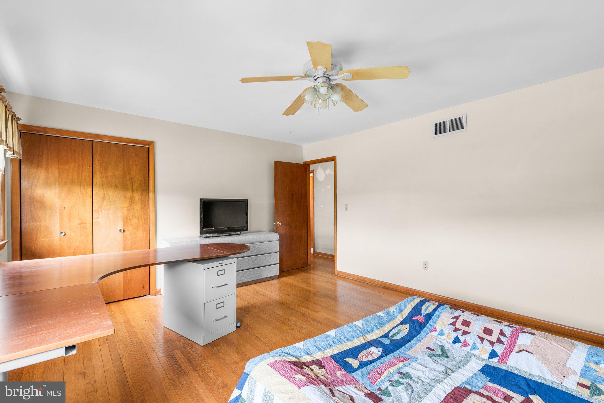 10110 Old Liberty Road Frederick, MD 21701 - Photo 17 of 65 a bedroom with a bed and a flat screen tv
