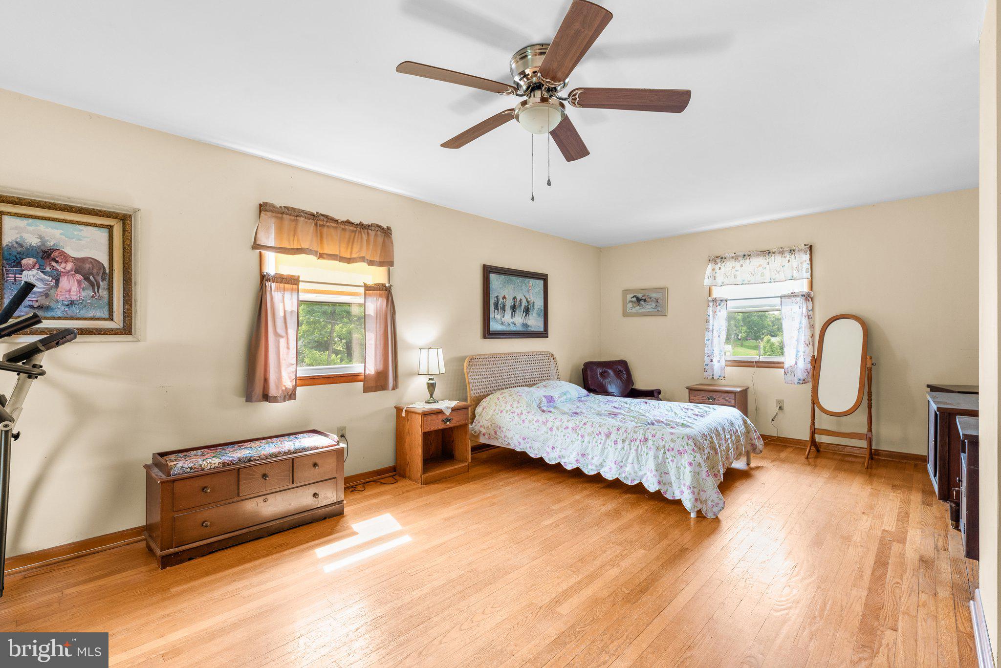 10110 Old Liberty Road Frederick, MD 21701 - Photo 20 of 65 a spacious bedroom with a bed a couch and a chandelier