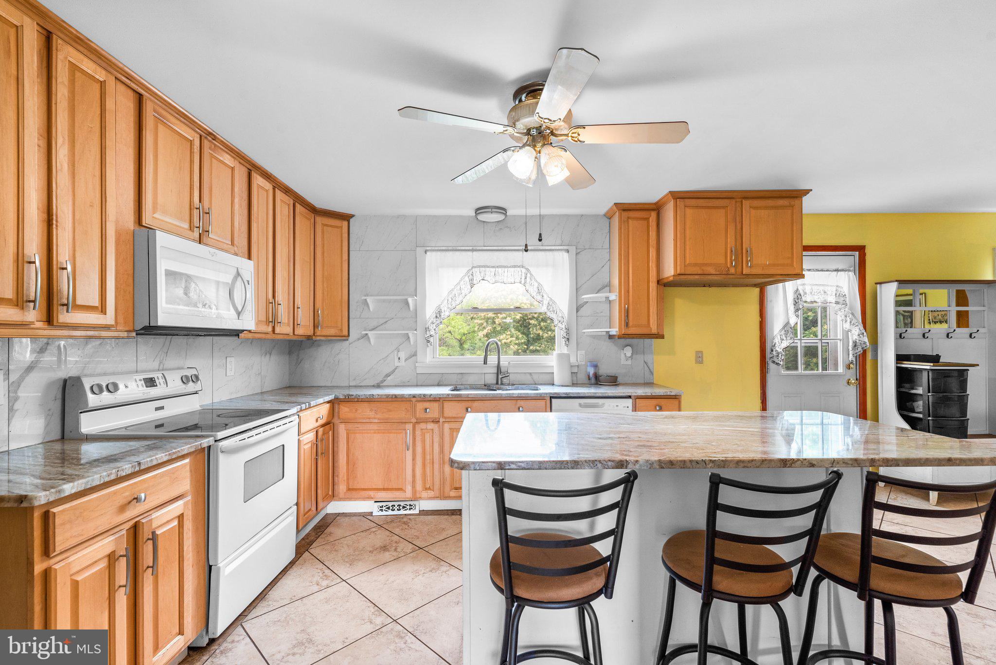 10110 Old Liberty Road Frederick, MD 21701 - Photo 4 of 65 a kitchen with stainless steel appliances kitchen island granite countertop a sink and cabinets