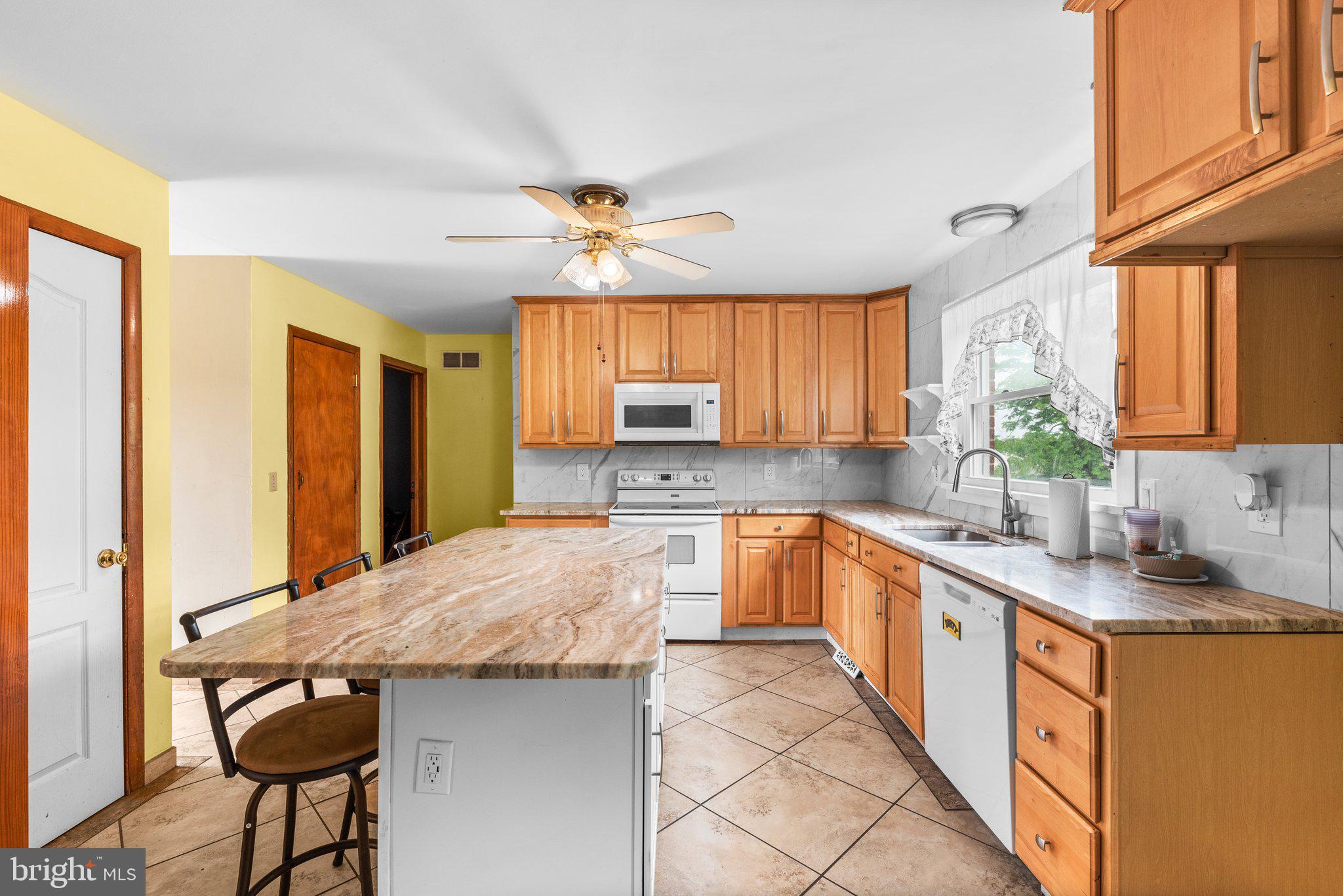 10110 Old Liberty Road Frederick, MD 21701 - Photo 59 of 65 a kitchen with stainless steel appliances granite countertop a sink and a refrigerator