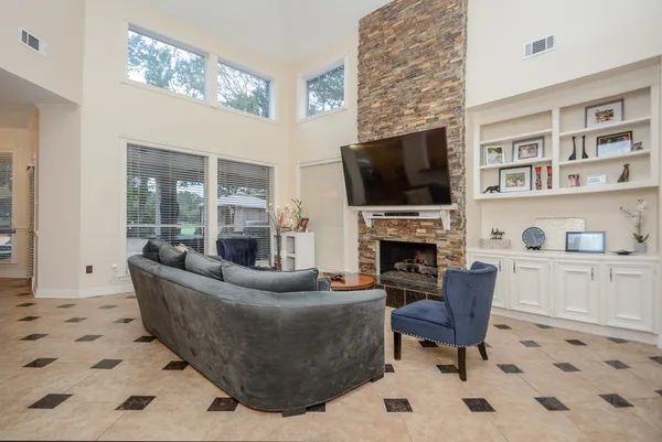 a living room with furniture a fireplace and a flat screen tv