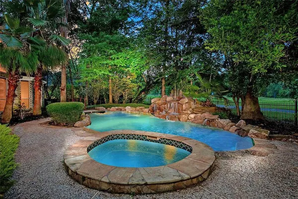 a view of a swimming pool with sitting area