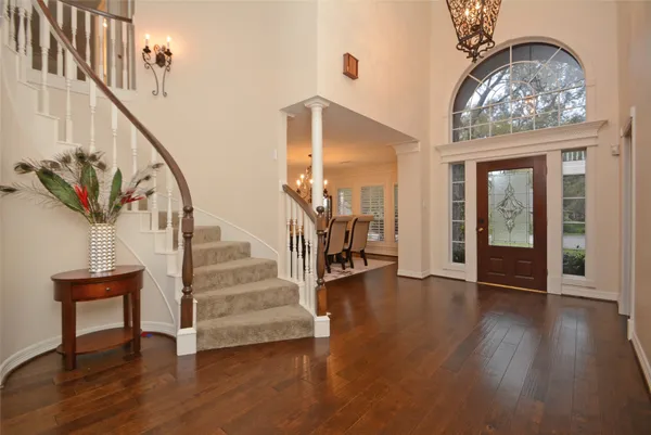 a view of entryway and hall with wooden floor