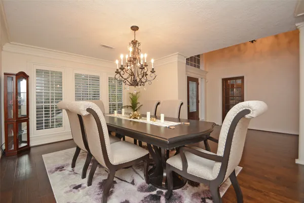 a view of a dining room with furniture wooden floor and chandelier