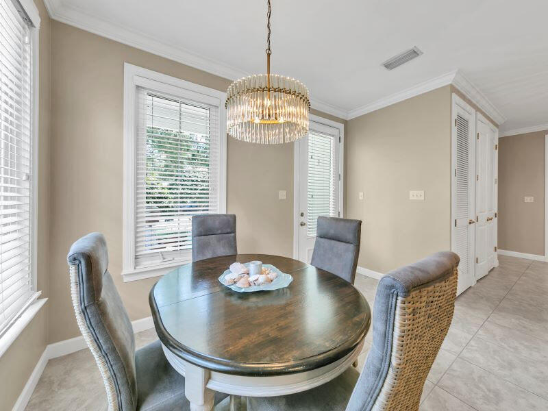232 South Zander Way Santa Rosa Beach, FL 32459 - Photo 3 of 26 a view of a dining room with furniture window and wooden floor