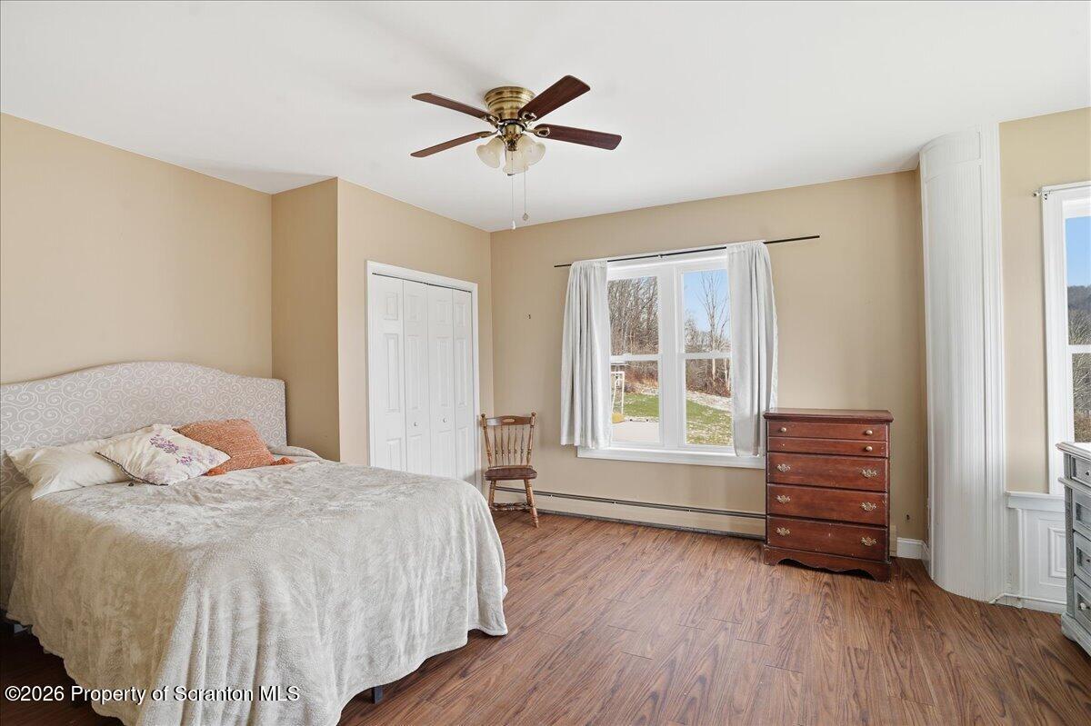 795 Wescott Road New Milford, PA 18834 - Photo 39 of 81 a bedroom with a bed and wooden floor