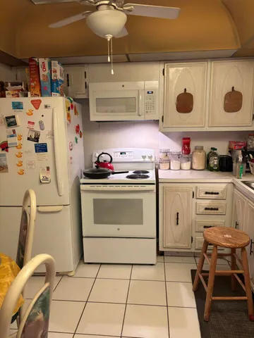 a kitchen with a sink a stove and cabinets