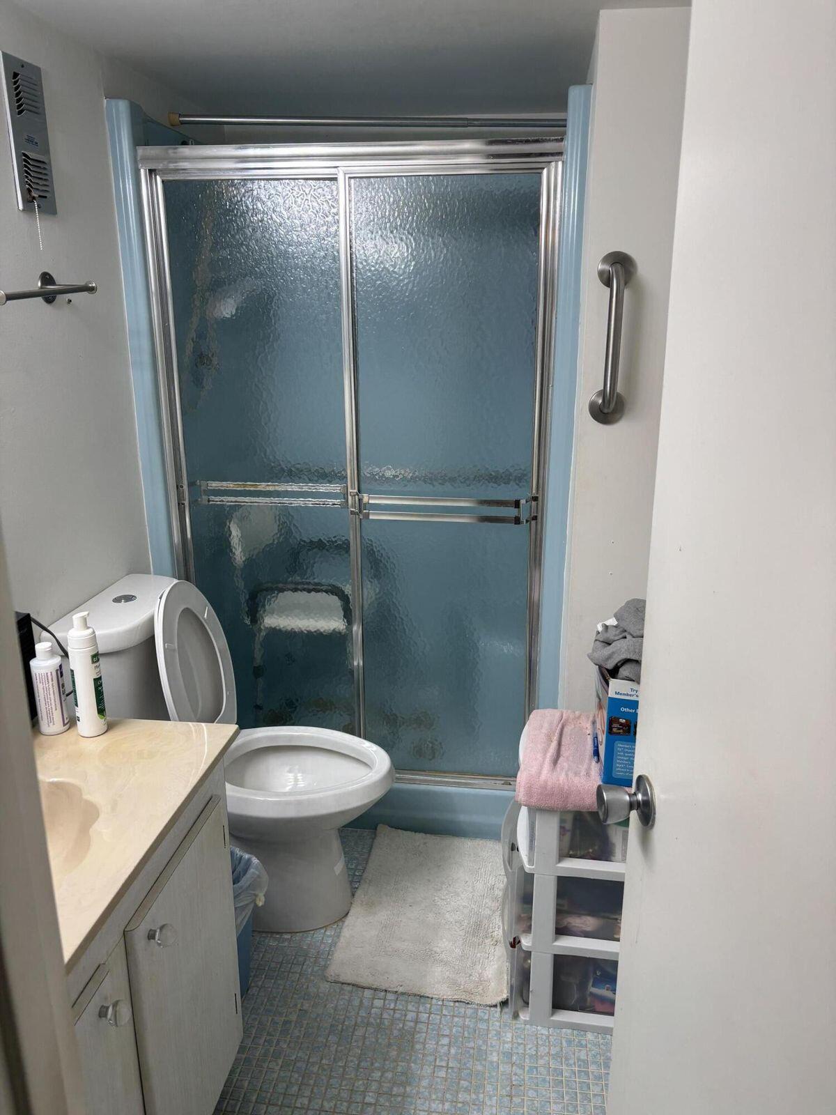 230 Northeast 26th Avenue, Unit 2140 Boynton Beach, FL 33435 - Photo 5 of 9 a white toilet sitting next to a bathroom sink